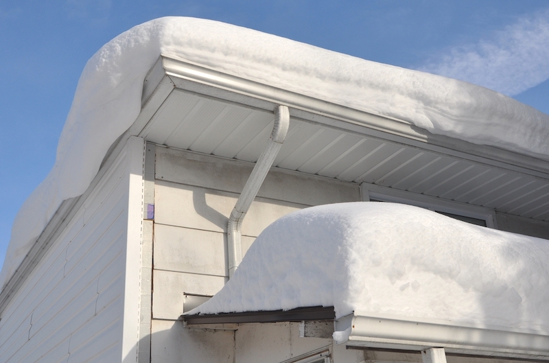 roof and gutters covered in snow
