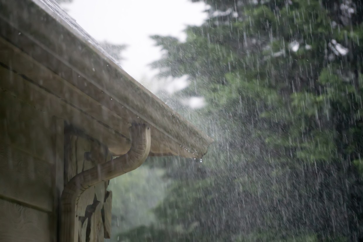 downpouring rain and gutter on home
