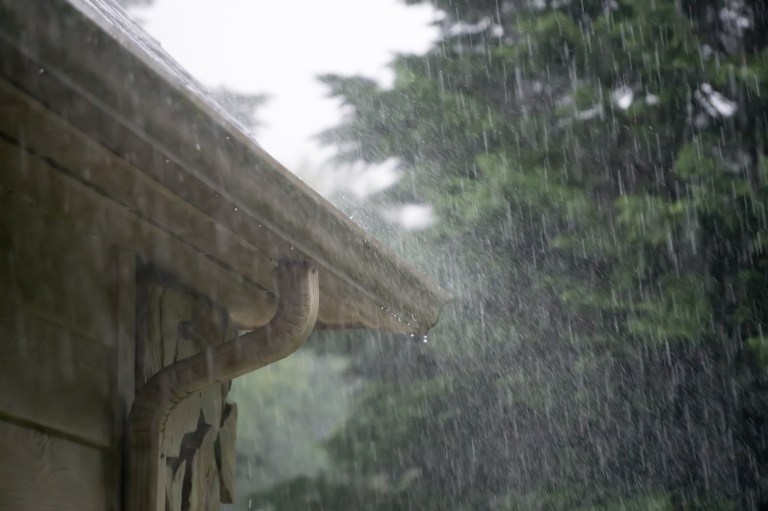 downpouring rain and gutter on home