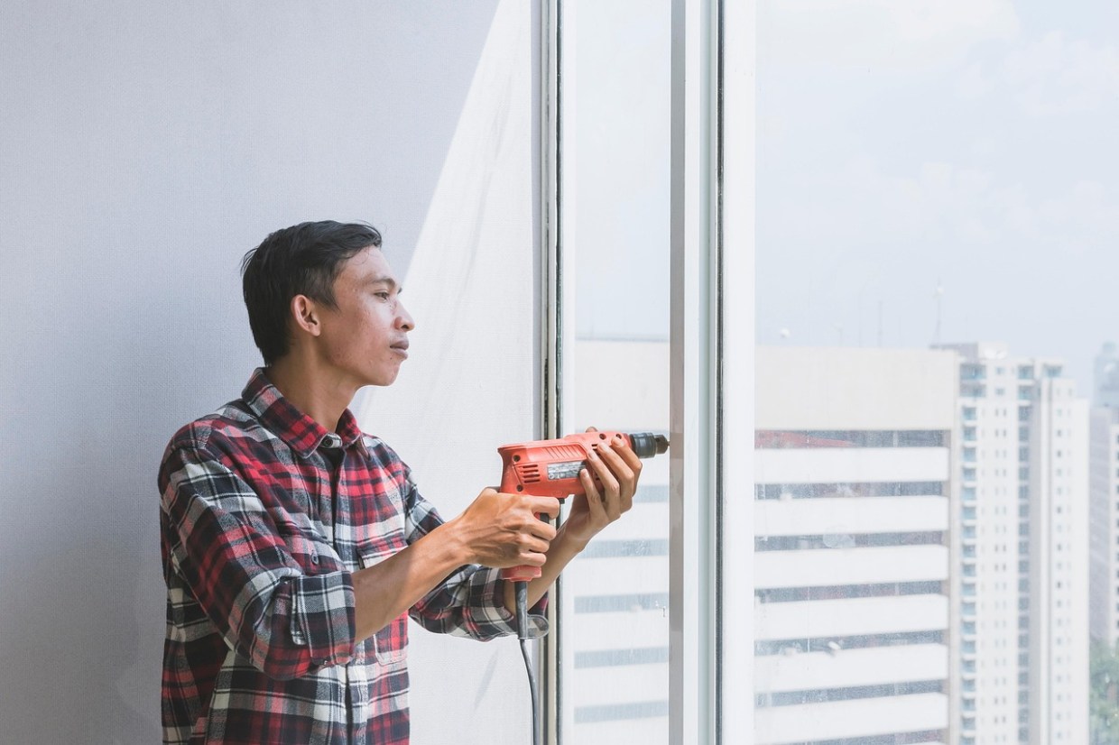man repairing sliding door
